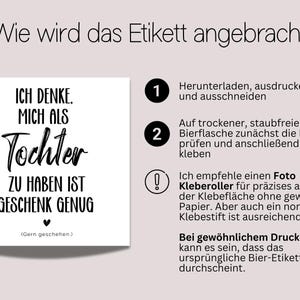 May include: A white square label with black text that reads "ICH DENKE. MICH ALS Tochter ZU HABEN IST GESCHENK GENUG" with a heart symbol. Instructions on how to apply the label are also included.
