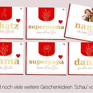 May include: A collection of greeting cards with gold lettering and red accents. The cards feature phrases like "schatz", "supermama", "mama", "superpapa", and "danke". One card includes a photo and the word "name".