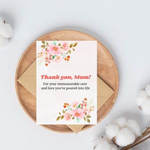 Puede incluir: Una tarjeta blanca con flores rosas y naranjas en la parte superior e inferior. La tarjeta dice "¡Gracias, Mamá! Por tu cuidado inconmensurable y el amor que has puesto en la vida."