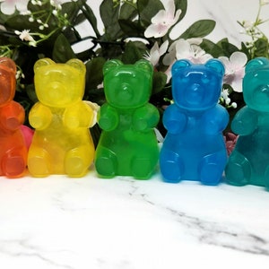May include: Seven gummy bear shaped soaps in a rainbow of colors. The soaps are red, orange, yellow, green, blue, turquoise, and purple.