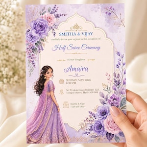 May include: A rectangular invitation card for a Half Saree Ceremony featuring purple and pink floral watercolor illustrations. The text includes the names Smitha & Vijay, the daughter Amaira, date Sunday, May 2026, 6:30 PM, and address details.