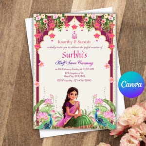 Puede incluir: Tarjeta de invitación para la ceremonia de medio sari de Surbhi. El diseño presenta una ilustración central de una mujer con vestimenta tradicional, enmarcada por motivos florales y pavos reales. El texto incluye los nombres Keerthy & Surosh, fecha, hora y detalles RSVP.