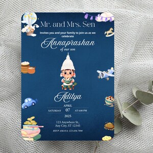 May include: A rectangular navy blue invitation card for an Annaprashan ceremony. The text reads Mr. and Mrs. Sen invite you to celebrate Annaprashan of our son Aditya on Saturday, April 07, 2025 at 6:00 PM. It features illustrations of a hot air balloon, a rocking horse, a small airplane, a car, books, and food items.
