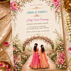 May include: A rectangular invitation card for a Half Saree Ceremony featuring floral borders and an illustration of two people walking under a flower arch. The text reads: Join us to celebrate, Akhila & Nikhila's, Half Saree Ceremony, Sunday, May 2026.