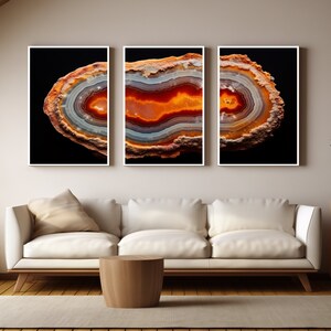 May include: Three framed prints of a colourful agate slice with a black background. The agate has a variety of colours, including red, orange, yellow, and white.