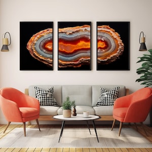 May include: Three framed prints of agate slices with a black background. The agate slices are a mix of orange, red, white, and grey colours.