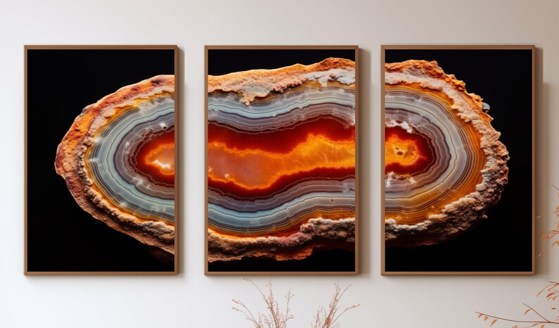 May include: A close-up of a tri-panel wall art print featuring a colourful agate slice with orange, red, and white bands. The agate is set against a black background.