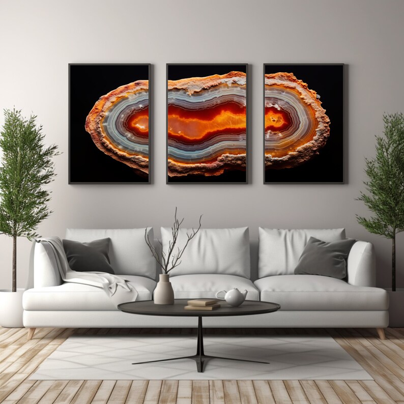 May include: A set of three framed prints featuring a close-up of a colourful agate slice with orange, red, and white bands. The agate is set against a black background.