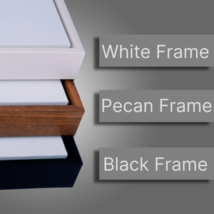 May include: Three canvas prints with different coloured frames. The top frame is white, the middle frame is pecan, and the bottom frame is black.