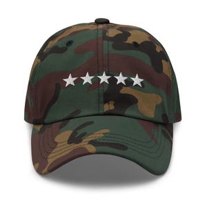 May include: A camouflage baseball cap with five white stars embroidered on the front.