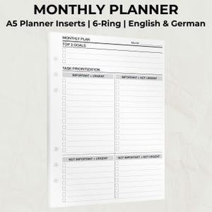 Könnte beinhalten: Weißer A5-Planereinsatz mit monatlichem Layout. Der Einsatz enthält Abschnitte für die Top 3 Ziele und die Aufgabenpriorisierung, mit Kategorien wie "Wichtig + Dringend". Der Text enthält "MONTHLY PLANNER".