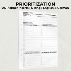 May include: White A5 planner inserts with a 6-ring binder design. The inserts feature sections for prioritization, including "Top 3 Goals," and quadrants for "Important + Urgent," "Important + Not Urgent," "Not Important + Urgent," and "Not Important + Not Urgent."