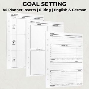 Pode incluir: Inserções de planejador A5 brancas com design de 6 argolas. As inserções incluem seções para metas de vida, metas anuais e acompanhamento de metas. O texto inclui "GOAL SETTING", "LIFE GOALS" e "GOALS".