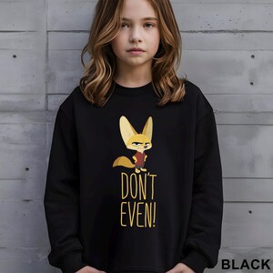 May include: Black sweatshirt with a cartoon fox illustration and the text "DON'T EVEN!". The fox has large ears and a serious expression. The word "BLACK" is printed in the bottom right corner of the sweatshirt.