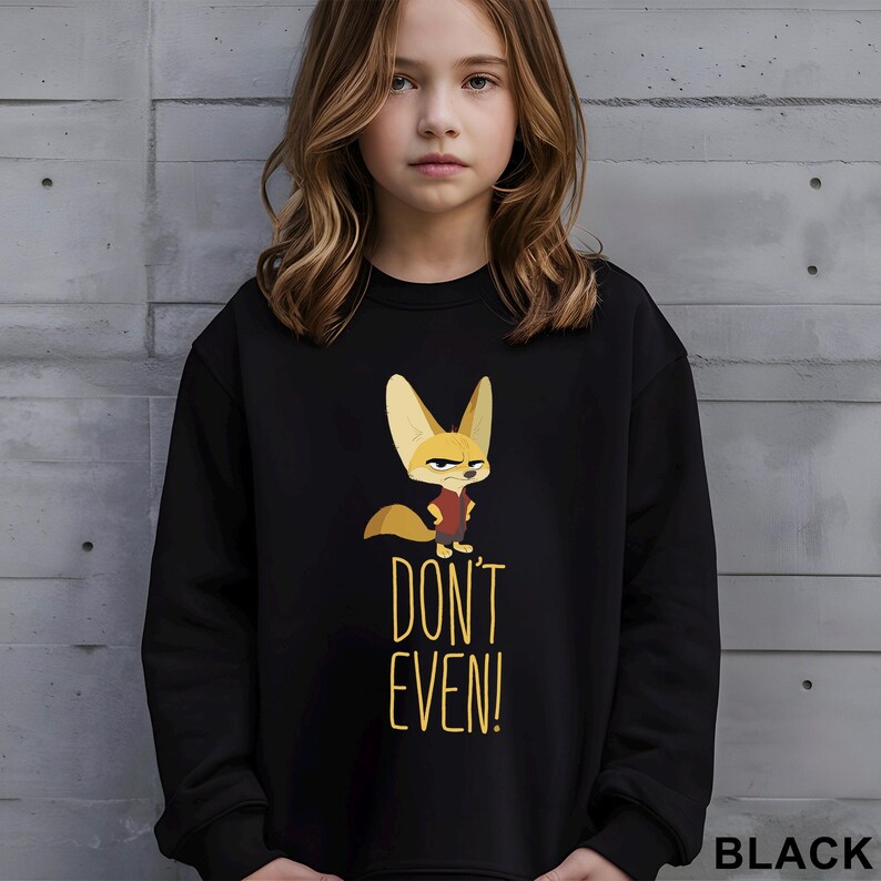 May include: Black sweatshirt with a cartoon fox illustration and the text "DON'T EVEN!". The fox has large ears and a serious expression. The word "BLACK" is printed in the bottom right corner of the sweatshirt.