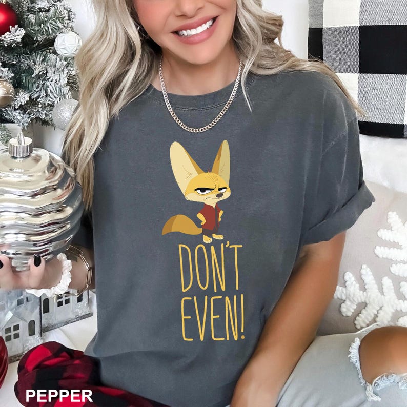 May include: Dark gray t-shirt featuring a cartoon fox with an angry expression, wearing a red vest. The text "DON'T EVEN!" is printed in yellow below the fox. The shirt is a comfortable, casual style.