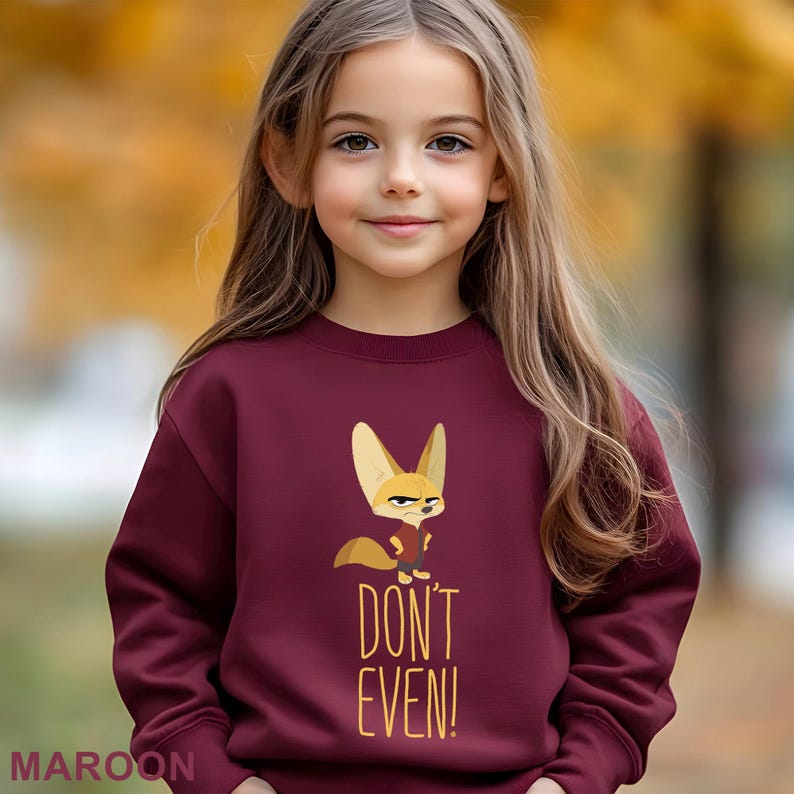 May include: Maroon sweatshirt with a cartoon fox and the words "DON'T EVEN!". The fox has large ears and a stern expression. The word "MAROON" is printed at the bottom of the sweatshirt.