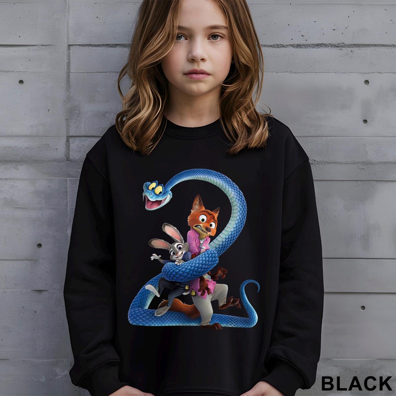 May include: Black sweatshirt featuring a colorful graphic of characters from the animated movie Zootopia, including a fox, a rabbit, and a blue snake. The word "BLACK" is printed in white at the bottom right corner.