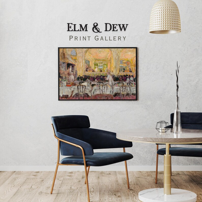 May include: A framed print of a restaurant scene hangs on a white wall. The painting depicts a dining room with tables, chairs, and figures. A modern blue chair with gold legs and a round table are in the foreground. The text "ELM & DEW PRINT GALLERY" is above the painting.