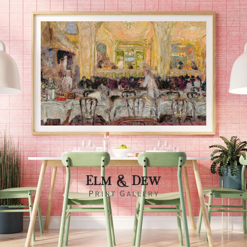 May include: A framed print of an impressionist painting depicting a restaurant scene with tables, chairs, and figures. The print is displayed above a table with green chairs. The text "ELM & DEW PRINT GALLERY" is below the table.