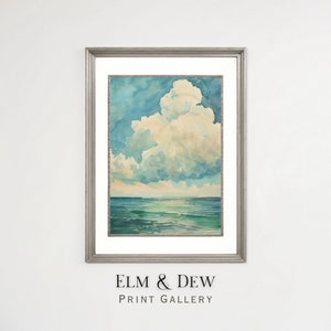 May include: A framed watercolor painting of a large, fluffy white cloud over a blue ocean. The sky is a light blue with hints of yellow and green. The ocean is a deep blue with hints of green and white.