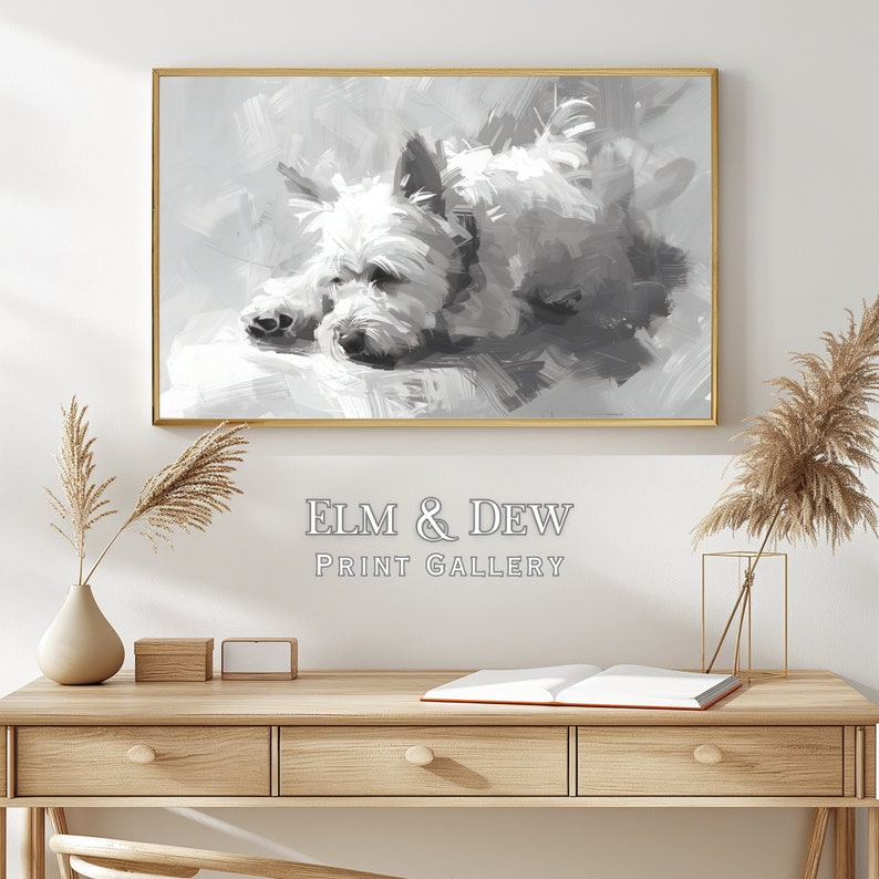 May include: Black and white painting of a dog lying down. The painting is framed in a gold frame and is hanging on a white wall. The painting is titled "ELM & DEW PRINT GALLERY".