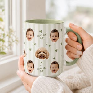 May include: A large ceramic mug with a green handle and interior. The mug features a light green and white striped pattern with images of a baby, a dog, and green hearts. The text "I LOVE YOU DAD" is also printed on the mug.