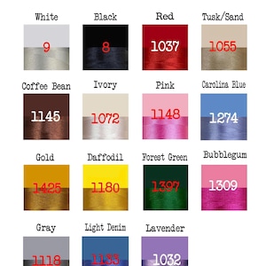 May include: A color chart displaying various thread colors. The chart includes colors like white, black, red, and gold, each paired with a corresponding number. The colors are displayed on a background of different shades.