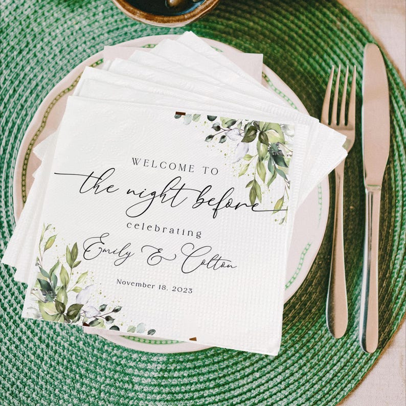May include: White paper napkin with green foliage and gold glitter. The text reads "Welcome to the night before celebrating Emily & Colton November 18, 2023".
