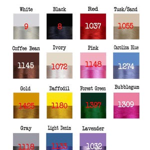 May include: A colour chart showing thread colours, including white, black, red, and gold, each with a number. The colours are presented against a gradient background. Measurements are not applicable.