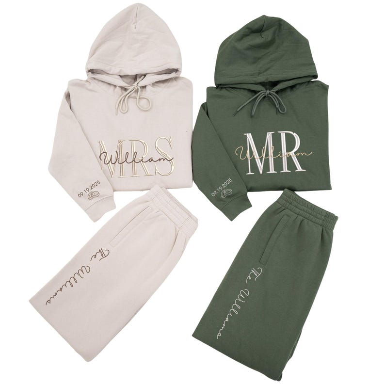May include: Two matching sets of hooded sweatshirts and sweatpants. One set is beige with "MRS William" embroidered on the front and "The Williams" on the pants. The other set is dark green with "MR William" embroidered on the front and "The Williams" on the pants.