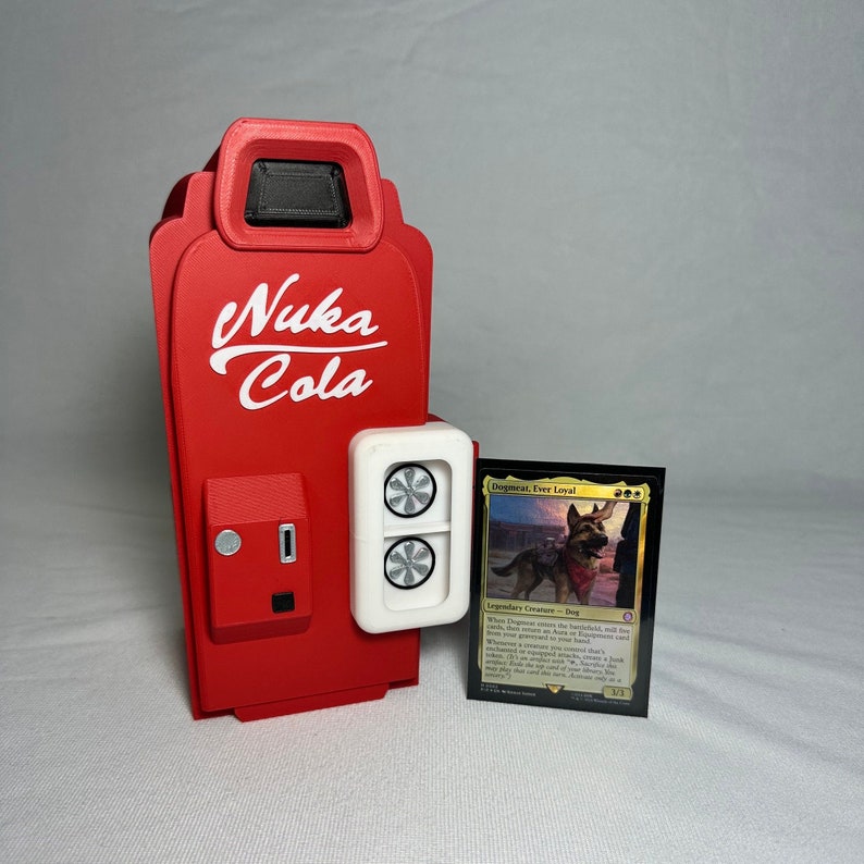 May include: A red and white Nuka Cola vending machine with a white panel featuring two black fans. A Magic: The Gathering card featuring a dog with a bandana is in front of the machine. The card text reads "Dogmeat, Ever Loyal - Legendary Creature - Dog. When Dogmeat enters the battlefield, exile the top card of your library. You may cast that card from your graveyard this turn. Whenever a creature you control deals combat damage to a player, exile the top card of your library. You may play that card this turn.  Dogmeat can't attack unless you control another creature.  4/4."