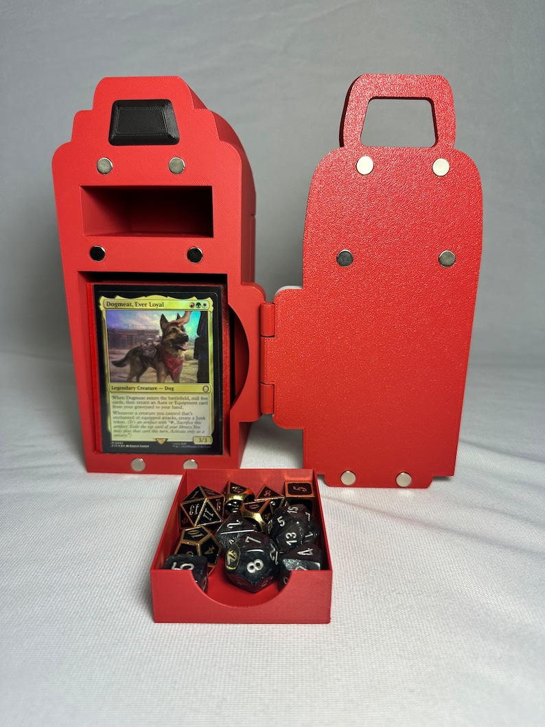 May include: Red wooden box with a hinged door, a small drawer, and a compartment for a card. The box is open and the drawer is pulled out, revealing black and gold dice inside. The card inside the box is a Magic: The Gathering card titled "Dogmeat, Ever Loyal".