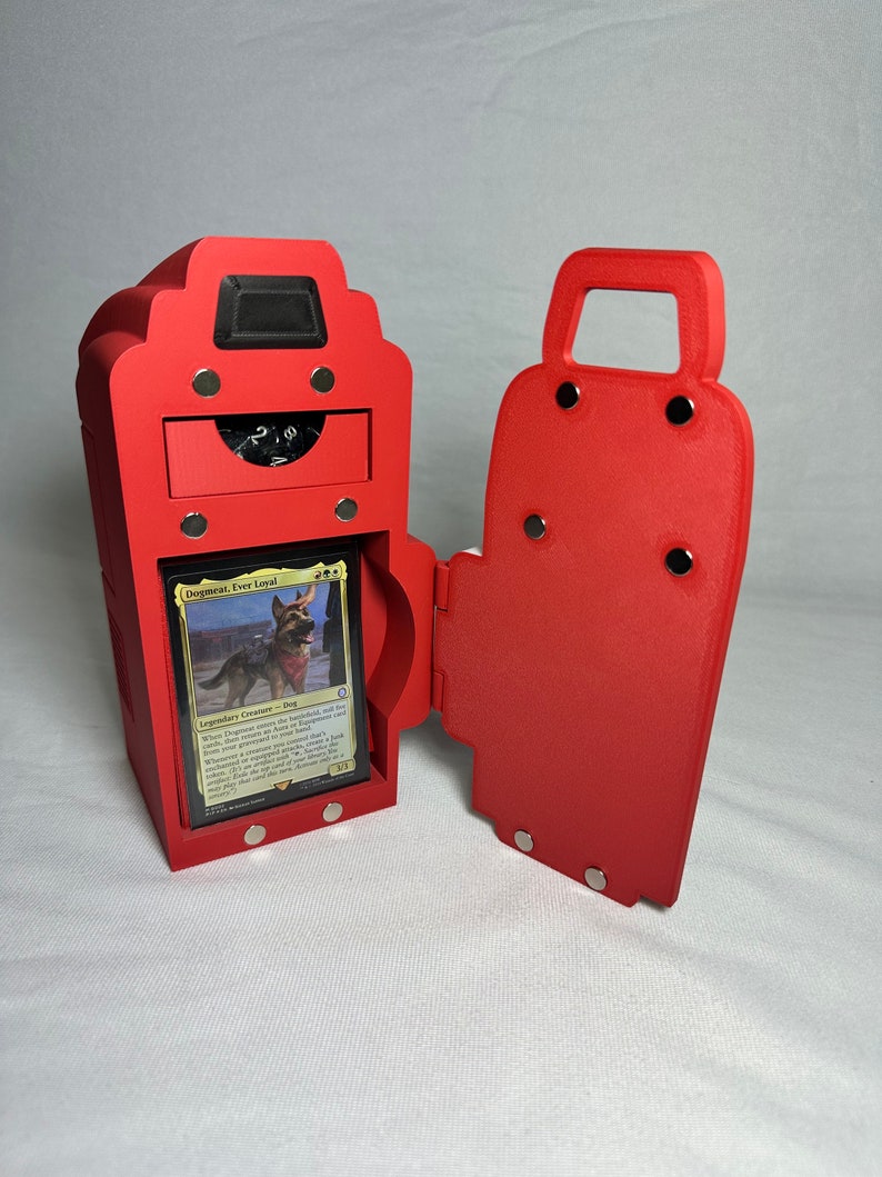 May include: Red, hinged, magnetic box with a drawer and a compartment for a trading card game deck. The box is open and a card with a dog on it is visible. The card reads "Dogmeat,  Very Loyal".