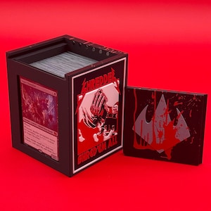 May include: Black card storage box with the word "SHREDDER" in red and a graphic of a hand. The box also has the text "SHRED 'EM ALL". A separate black card holder is next to the box.
