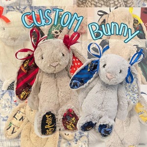 May include: A collage of plush stuffed bunnies featuring various fabric patterns on their ears and feet, including Harry Potter house crests, Hello Kitty, and sports team logos. Each bunny is adorned with a colorful ribbon tied at the ear base.