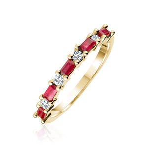 May include: A gold ring with alternating rectangular red gemstones and round white gemstones. The ring has a polished finish. The gemstones are evenly spaced along the band. The ring is set against a white background.
