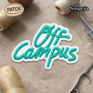 May include: An embroidered patch with the words "Off Campus" in teal script, outlined in white. The patch is on a beige fabric background, with spools of thread and a pair of scissors visible. The word "PATCH" is on a small wooden patch.