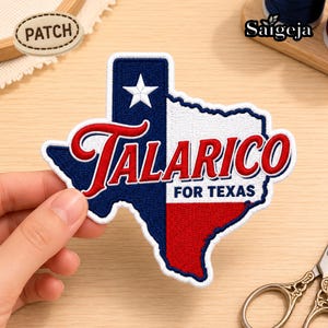 May include: An embroidered patch shaped like the state of Texas featuring the Texas flag design with a blue vertical stripe, a white star, and red and white horizontal stripes. The text TALARICO FOR TEXAS is stitched in red and blue thread.