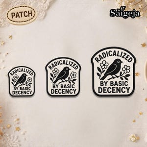 May include: Three black and white patches with the text "RADICALIZED BY BASIC DECENCY" and a bird perched on a branch with flowers. The patches are in different sizes and shapes.