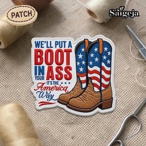 Puede incluir: Parche bordado con un par de botas de vaquero con el diseño de la bandera estadounidense. El parche incluye el texto "We'll put a boot in your ass, it's the America way" en rojo y azul.