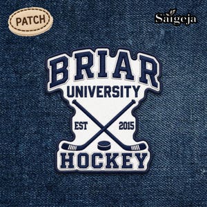 May include: A navy blue and white embroidered patch with the words "BRIAR UNIVERSITY HOCKEY", crossed hockey sticks, and a puck. The patch also includes "EST 2015". A small, oval patch with "PATCH" is in the upper left corner.