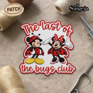 May include: Embroidered patch featuring Mickey and Minnie Mouse dressed as ladybugs. The patch has a white background with red text that reads "The last of the bugs club". The characters are in red and black ladybug costumes with yellow and pink accents.