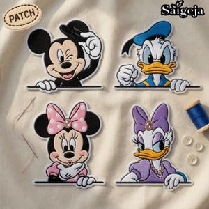 May include: Set of four embroidered patches featuring Mickey Mouse, Donald Duck, Minnie Mouse, and Daisy Duck. Mickey winks, Donald clenches his fists, Minnie has a pink bow, and Daisy wears a purple bow. The patches are on a cream-colored fabric.