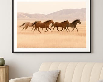 May include: Framed art print featuring a herd of wild horses galloping across a field. The horses are various shades of brown and tan, set against a backdrop of rolling hills and a pale sky. The artwork is framed in a black border.