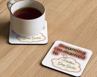 May include: Two square white coasters with a black border. One coaster has a cup of tea on it. The coasters have a cloud design with the text "Gray Gubler" and "Dreaming I'm married to Matthew Gray Gubler".