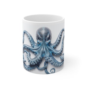 May include: White ceramic mug with a blue octopus design. The octopus has a detailed, textured design and large, dark blue eyes.