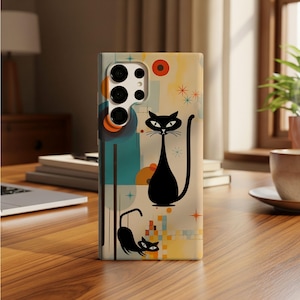 May include: A rectangular smartphone case featuring a cream-colored background with two stylized black cats. The design includes geometric shapes in teal and orange, along with small starburst patterns in blue and orange scattered across the surface.