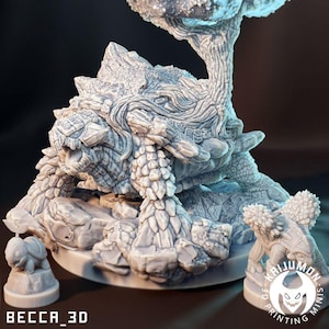 May include: A detailed, grey 3D-printed sculpture of a fantasy creature, resembling a turtle with a tree growing from its back. The sculpture includes smaller turtle figurines and the text "BECCA_3D" and "KAIJUMON 3D PRINTING MINIS".