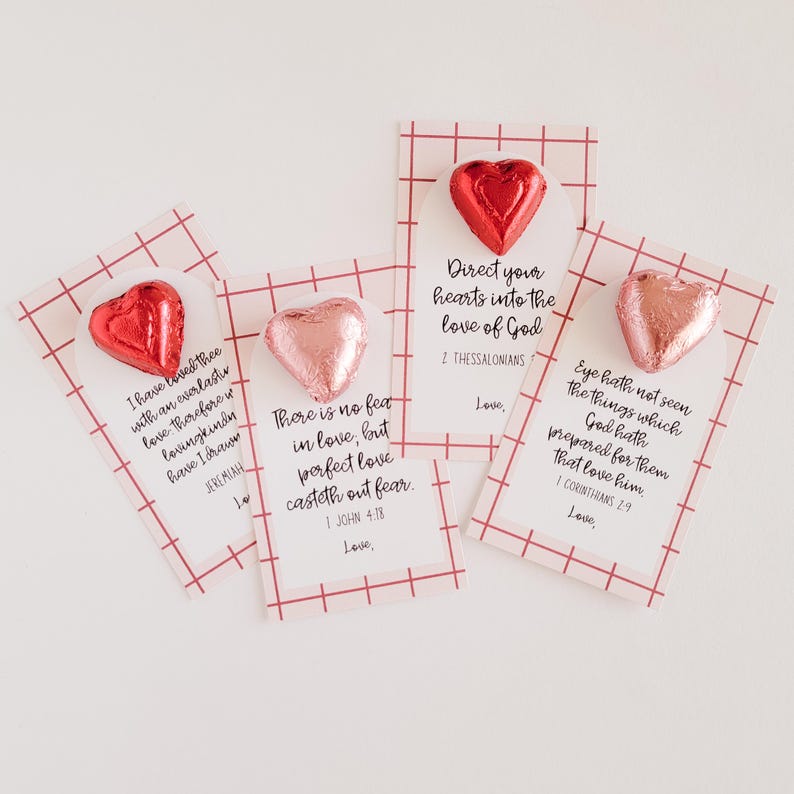 May include: Four Valentine's Day cards with pink and red foil-wrapped chocolate hearts and inspirational quotes about love. The cards have a red and white gingham background.